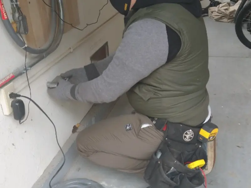 Electrician performing outlet wiring in a South Berwick garage